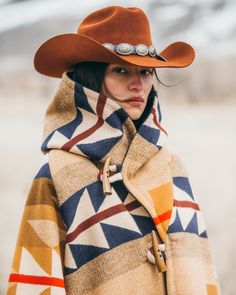 Most Orders Ship within 1-2 Business Days Fully lined hooded cloak with a straight fit, raglan sleeves, welt patch pockets and four horn toggle closures. Celeste is 5'10" and wears size OS. Pendleton blankets: 82% Wool, 18% Cotton. Wool Cashmere facings and Silk Rayon peachskin lining. Native American tribes traveled to Wyoming’s Medicine Bow Mountains to harvest wood for especially fine bows. In this design, stands of wood alternate with arrows that meet in the center to evoke the Medicine Bow Pendleton Blankets, Looks Country, Cowgirl Chic, Hooded Cloak, Native American Tribes, Cotton Wool, Mode Inspiration, Western Outfits, Cloak