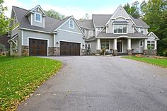 a large house with two garages and lots of windows