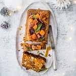 a white plate topped with food on top of a table next to a christmas tree