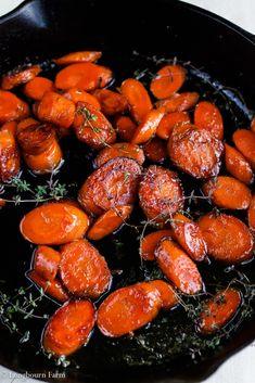 cooked carrots with herbs cooking in a skillet