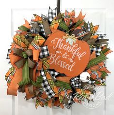 an orange and black wreath with the words, happy thanksgiving and blood written on it