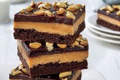 a stack of brownies sitting on top of a white plate