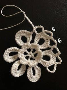 the crocheted flower is being worked on