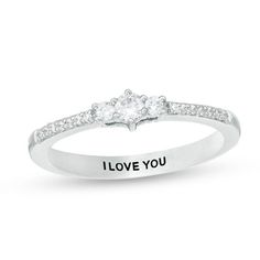 a white gold ring with i love you written on the side and diamonds in the middle