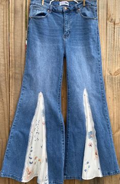 a pair of blue jeans with white flowers on them