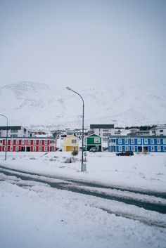 a street with snow on the ground and buildings in the backgroung area