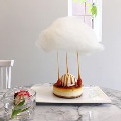 there is a dessert on the table with clouds above it