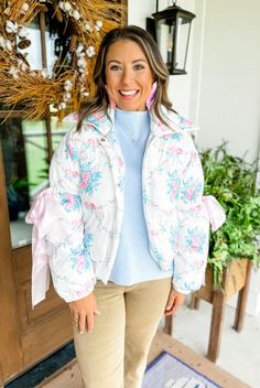 Girls, get ready to be charmed by our "Cozy Charmer Floral Puffer Jacket"! It is giving full-on grandmillenial vibes and features the prettiest pink and blue floral print, functional pink satin bows on the elbows, a collar, a full zipper front, and an elastic banded bottom. It is on the thicker side, so you will be ready for the cool days coming! FABRIC: 100% Polyester FIT: Fit is relaxed, bottom band is fitted SIZING: We recommend buying your normal size! MODELS: Kristen is 5'4", a small-medium Fabric Stain Remover, Fabric Stains, Headband Jewelry, Sparkle Shoes, Puff Jacket, Camo Shirts, Blue Floral Print, Christmas Tees, Fall Sweaters