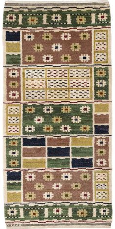 a multicolored area rug with squares and crosses on the bottom, in various colors