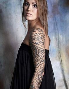 a woman with tattoos on her arm and shoulder