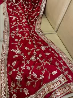 a red and gold embroidered sari