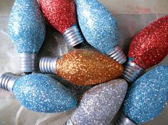 several light bulbs with glitter on them are arranged in the shape of a christmas ornament