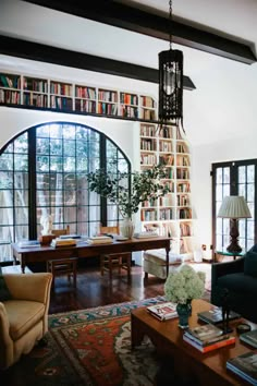 a living room filled with furniture and lots of books