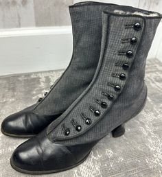 "One of many Antique boots that we have for sale in our Etsy TeaTimeClothing shop. A fabulous example of authentic Antique womens Button boots from this era. Two tone boots: Jet black smooth leather with gray pinstripe wool fabric uppers (refer to Photos) . Button up details with Naturally distressed details. Cotton twill lining.  9\" inches tall, and 12 sets of buttons in this pair of button boots. Black Leather sole.*Refer to last photo and condition comments below for Size: no size indicated, Victorian Boots For Formal Fall Occasions, Fitted Vintage Black Boots, Victorian Black Boots With Round Toe, Black Victorian Boots With Round Toe, Victorian Black Boots For Formal Occasions, Black Victorian Boots For Formal Occasions, Vintage Fitted Boots For Winter, Vintage Fitted Cap Toe Boots, Fitted Vintage Cap Toe Boots