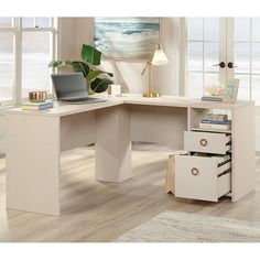 a white desk with drawers and a laptop on it