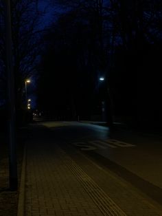 an empty street at night with no one on it or people walking down the sidewalk