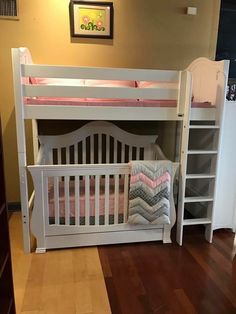 a white bunk bed sitting next to a wooden floor