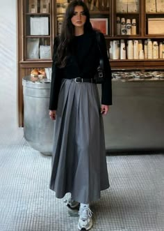 a woman standing in front of a counter