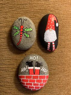 three christmas themed rocks on a table