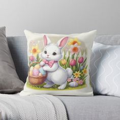 a white bunny holding an easter basket with eggs in it