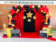 a red carpet with black and gold balloons