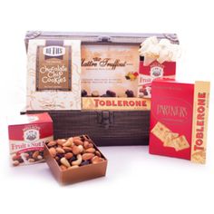 an assortment of nuts and chocolates in a suitcase on a white background with the words toblerone written below it