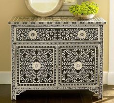 an ornate black and white cabinet with flowers on top is featured in this ad for daktotadave com