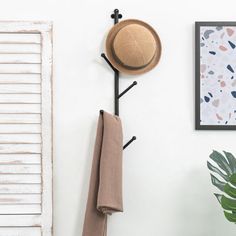 a hat and scarf hanging on a coat rack