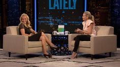 two women sitting in chairs talking to each other on the set of late with jayy