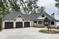 a large house with two garages in front of it