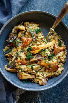 a blue bowl filled with rice and mushrooms