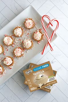 small cupcakes with sprinkles and candy cane on a plate