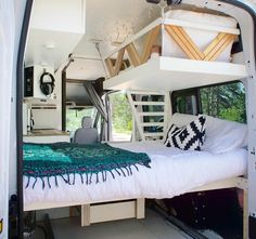 the interior of a camper van with a bed in it