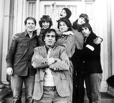 a group of people posing for a photo in front of a building