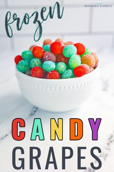 a white bowl filled with gummy bears on top of a marble counter next to the words frozen candy grapes