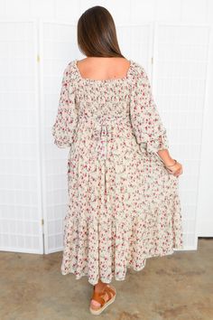 Step up your style game with the Meadow Muse Floral Midi Dress , a cute and feminine floral maxi dress that is sure to make a statement. Its full sleeves, ruched bodice, and pockets add both flair and functionality. For a more customized look, you can switch the waist tie from front to back, allowing you to play up your personal style. This flirty dress is perfect for any fall occasion, whether it's a cozy dinner party or a glamorous wedding. With its full, quarter-inch puff sleeves, smocked bod Flowy Long Sleeve Floral Dress For Casual Wear, Modest Long Sleeve Maxi Dress With Smocked Back, Ruched Maxi Floral Dress For Garden Party, Ruched Floral Maxi Dress For Garden Party, Modest Flowy Ruched Maxi Dress, Modest Ruched Dress For Garden Party, Fall Floral Print Maxi Dress With Square Neck, Spring Maxi Dress With Smocked Bodice And Long Sleeves, Flowy Long Sleeve Maxi Dress For Garden Party