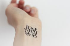 a person's arm with a tattoo that says love and joy on it,