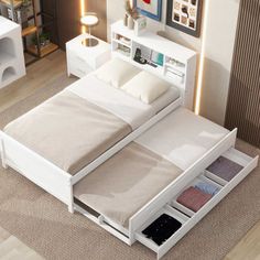 a white bed with drawers underneath it