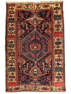 an antique persian rug with many different colors and patterns