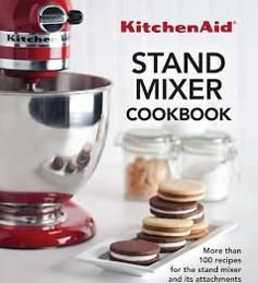 the kitchen aid stand mixer cookbook has cookies on it and is ready to be used as an appliance