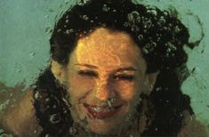 a woman with water on her face in the water and bubbles coming out of her mouth