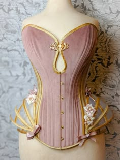 "Visit our website www.valkyriecorsets.com to see more of our designs or follow us on Instagram to see our bespoke work. This beautiful elaborate corset is made from dusky pink luxurious velvet, sheer corsetry mesh and stunning gold silk dupion. With detachable gold silk and mesh panniers. If you are interested in having this corset made in different colours send us an email to discuss your requirements. This corset is cut to give a 4-5\" waist reduction and includes a mock up sent to you to che Unique Corset Dresses, Overbust Corset Outfit, Haute Couture Corset, Rococo Corset, Glass Corset, Corset And Skirt Outfits, French Corset, Bridgerton Theme, Nigerian Traditional Dresses