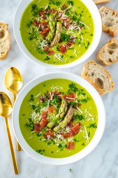 two white bowls filled with soup and garnished with parmesan cheese