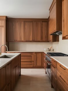 a kitchen with wooden cabinets and white counter tops