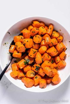 a white bowl filled with sliced up carrots