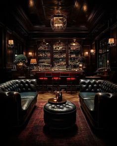 a dimly lit room with leather couches and tables