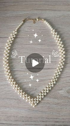 a white necklace with pearls on it and the words turbal written in black