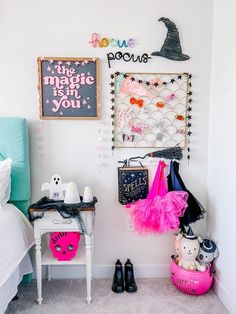 a bedroom with pink and black decorations on the wall