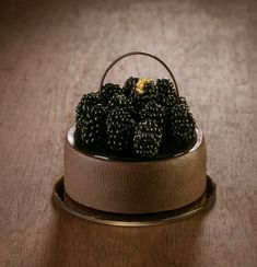 some blackberries are sitting in a basket on a table