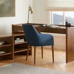 a blue chair sitting in front of a wooden desk